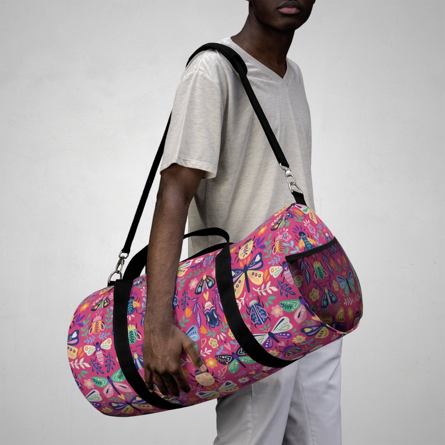 Man carrying duffle bag with butterfly print
